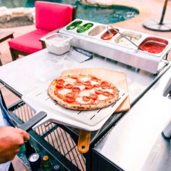 Ooni 12-Inch Perforated Pizza Peel 9 Ooni 12-Inch Perforated Pizza Peel -BBQ Haven Shop Ooni 12 Inch Perforated Pizza Peel Fits Ooni Fyra 12 Koda 12 and Karu 12 Lifestyle 1