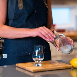 The Apres Supply Co. The Denim BBQ Apron - Recycled Cotton Denim With Leather Trim -BBQ Haven Shop The Apres Supply Co The Denim BBQ Apron Recycled Cotton Denim with Leather Trim Lifestyle